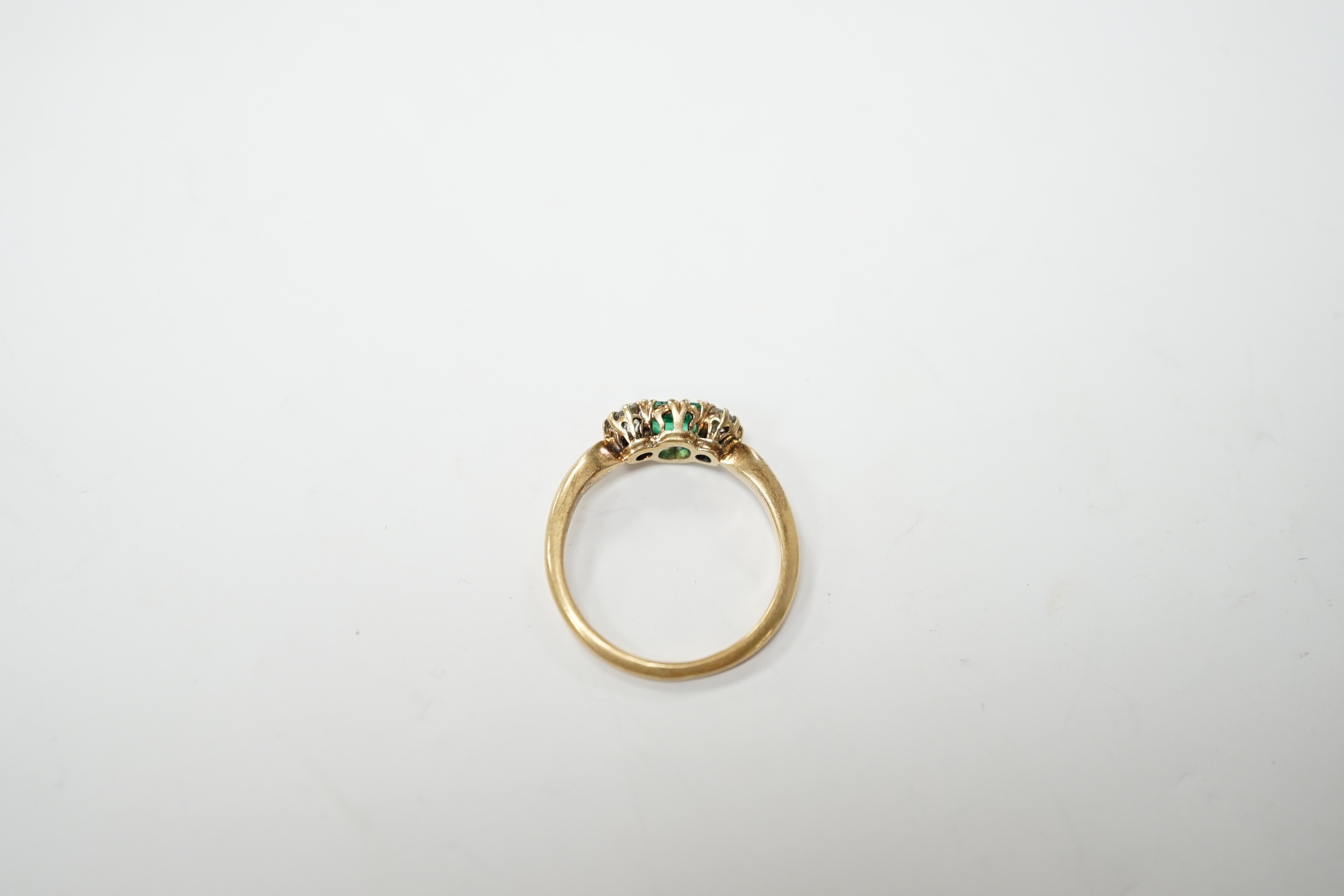 An early to mid 20th century 18ct, emerald and diamond set three stone ring, size O/P, gross weight 2.9 grams.